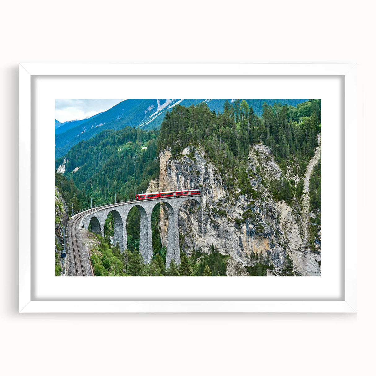 Abstract train print in muted gray and blue, framed with a white mat, suitable for dining room decor.
