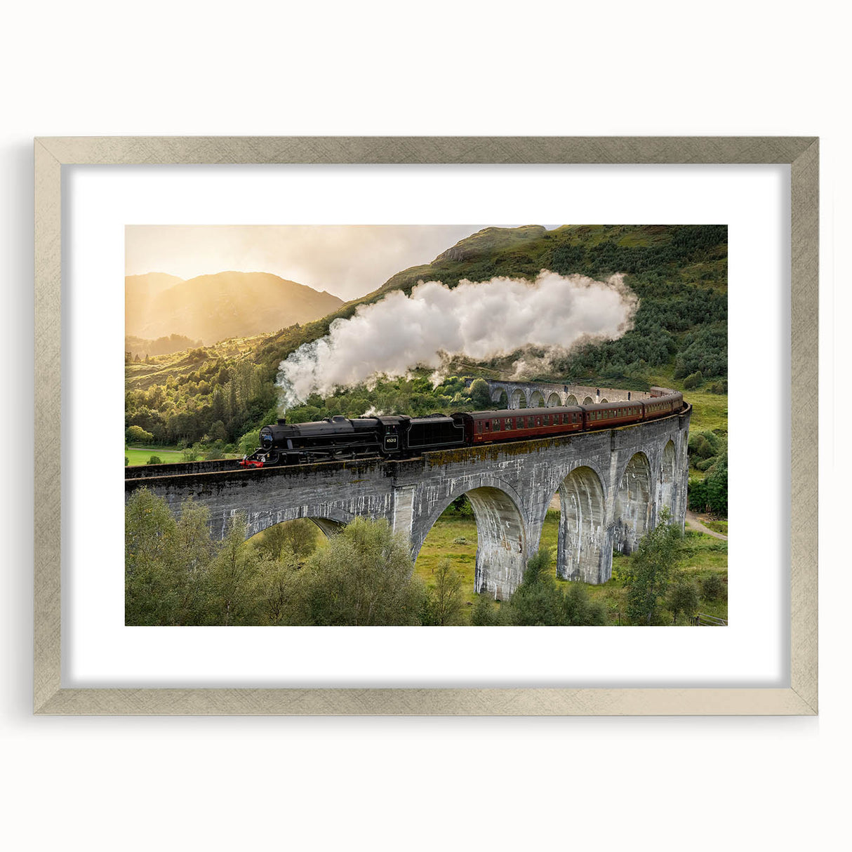 Textured art print of an abstract train in muted gray and blue tones, framed in silver, ideal for bedroom wall decor.