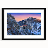 Extra large, colorful abstract art print of a stylized train, in a black frame with mat, ideal for living room decor.