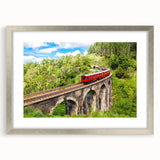 Textured art print of an abstract train in muted grays and blues on a silver-framed mat, ideal for bedroom decor.